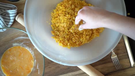 Woman-Meat-Breading-Chicken-Breast-into-Cornflakes