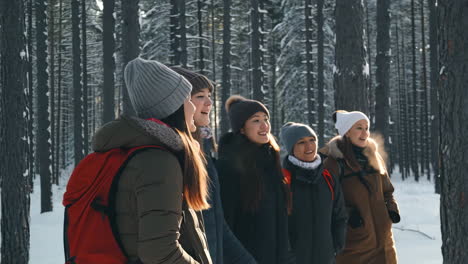 group of women in a snowy forest