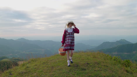 female caucasian blonde model in old fashioned traditional european clothing walking alone in mountains landscape slow motion