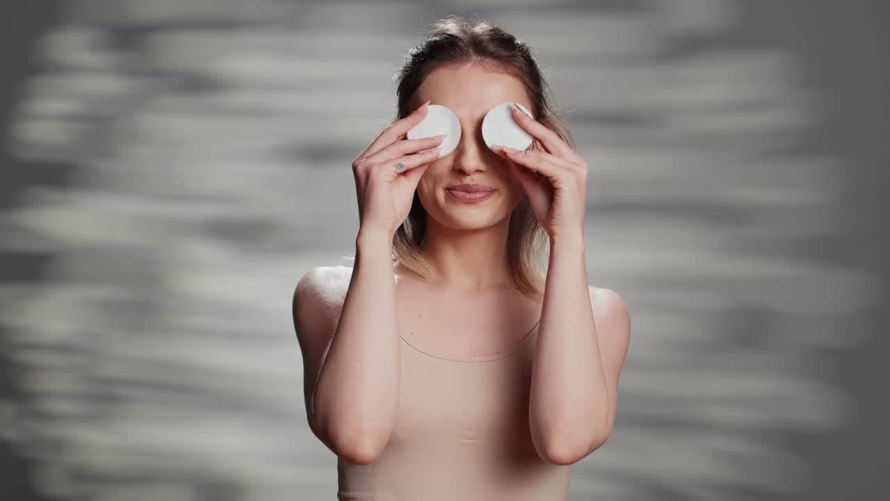 Woman using cotton pads for skincare