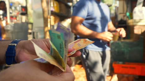 close-up of male hands counting a stack of indian banknotes, a businessman is counting cash, selective focus