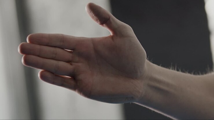 Person's hand touching a surface