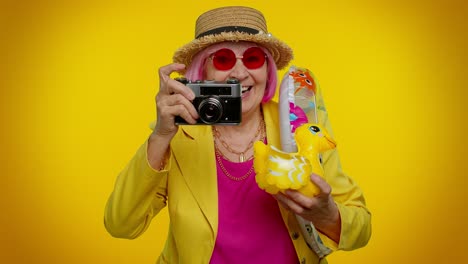 elderly woman grandmother tourist photographer taking photos on camera, travel, holiday vacations