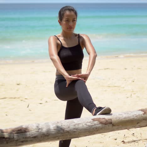 Woman-warming-up-on-beach