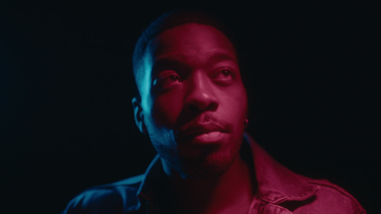 Young Black Man Dancing in Neon Lights