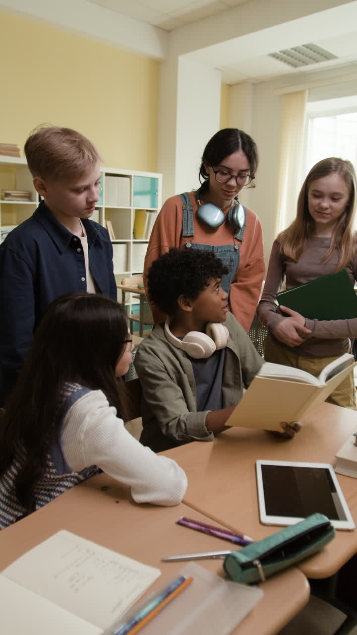 Students Collaborating and Reading a Book in a Classroom
