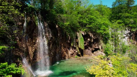Aerial-View-of-Waterfall-in-Plitvice-Lakes-National-Park,-Croatia-on-Sunny-Summer-Day,-Revealing-Drone-Shot