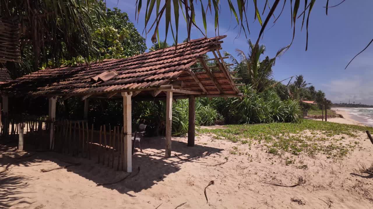 Abandoned looking sun shade shelter on the beach Sri Lanka remote paradise
