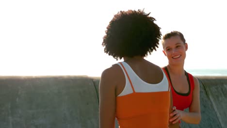 two sporty women jogging each on one side