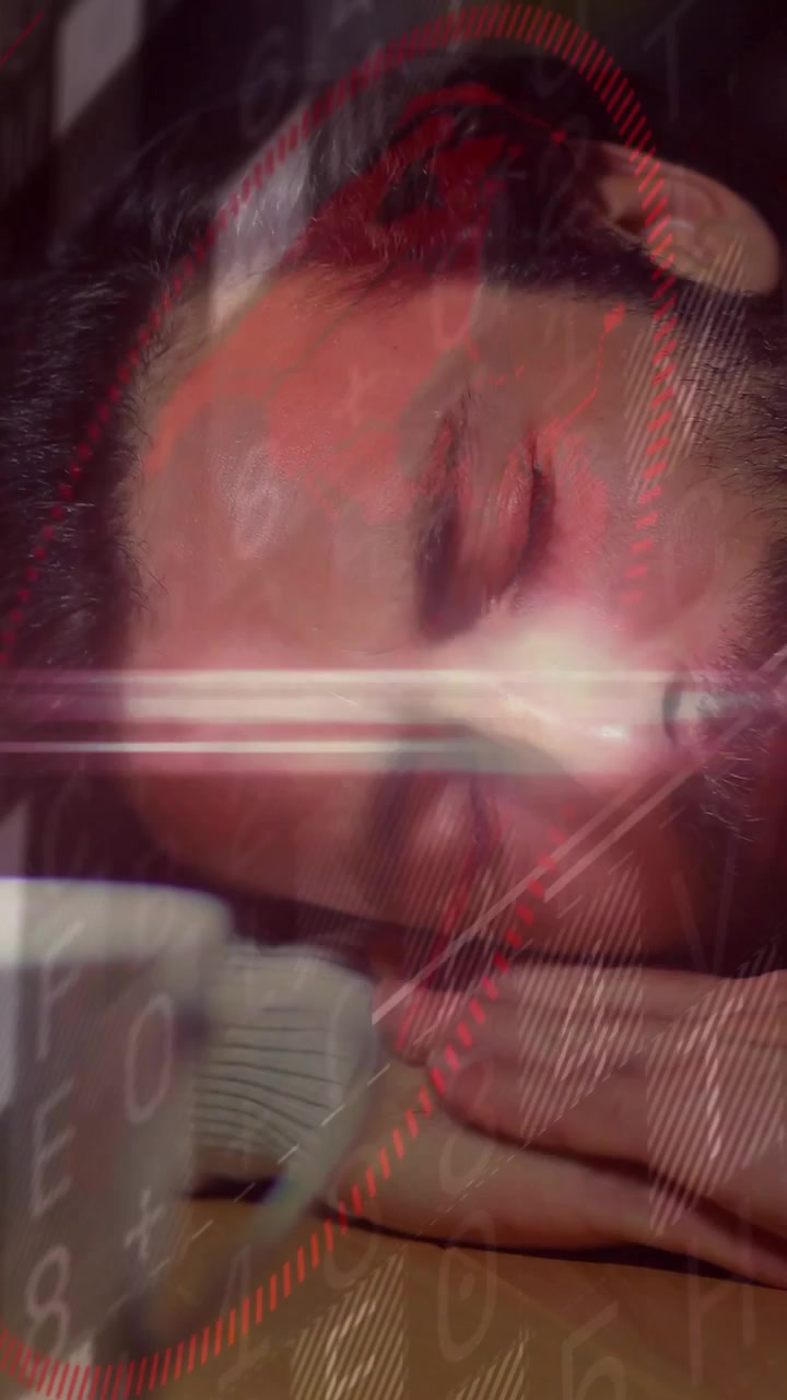 Vertical video: Man taking call, resting tired on desk while tech overlay showing keypad red clocks