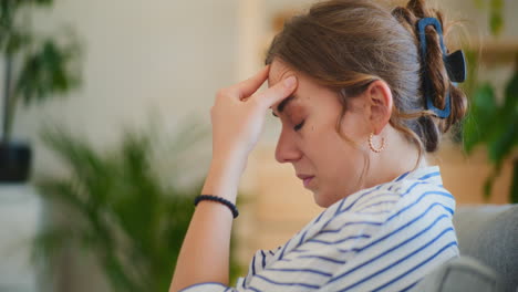 upset businesswoman contemplating on sofa