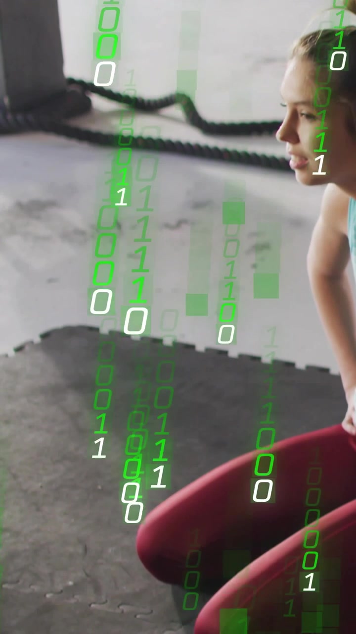 Vertical video: On rest woman kneeling breathing in gym as neon binary falling over woman and rope