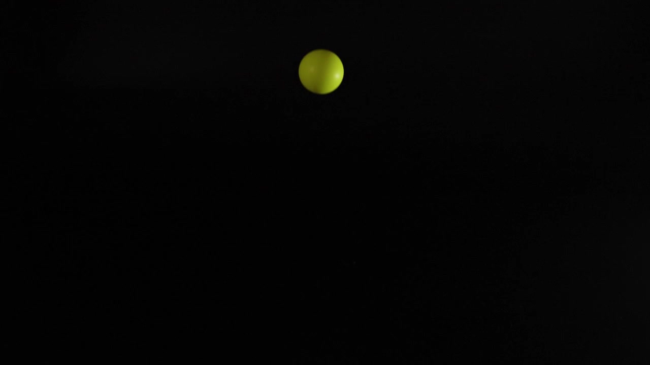 Yellow ball bouncing against a dark background