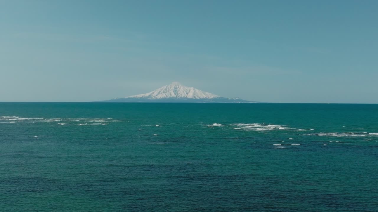 Majestic Snow-covered Mount Rishiri Across The Sea Of Japan In Hokkaido. wide shot