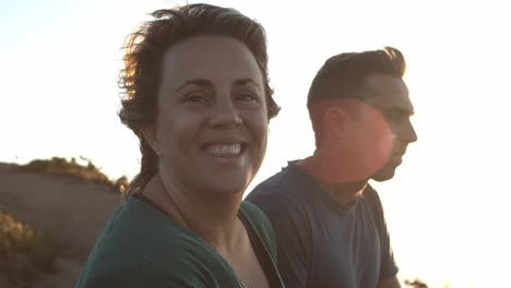 Couple-of-peaceful-tourists-sitting-at-cliff