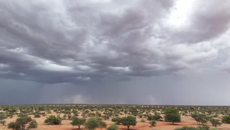 the southern kalahari landscape, a thunderstorm with lightning arriving in the distance