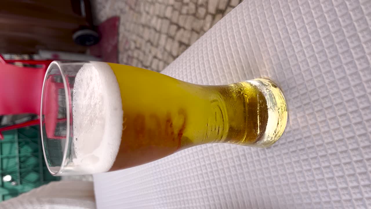 Static view of a glass of bubbly beer. Vertical format for social media