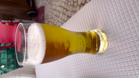 static view of a glass of bubbly beer. vertical format for social media