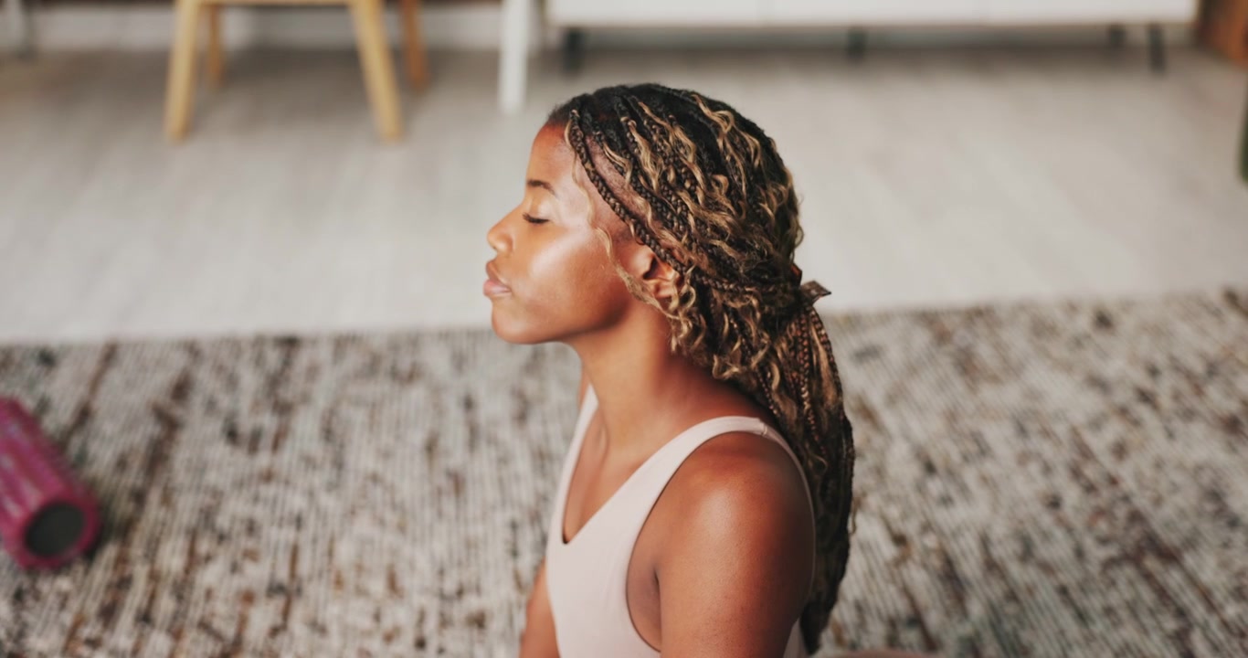 Young Woman Practicing Yoga Cobra Pose at Home
