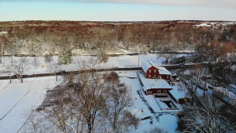 aerial view of snow-covered barn and forest in michigan, usa