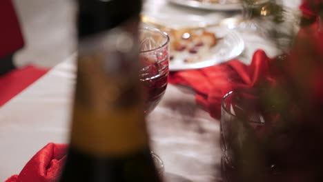 panning shot of a dinner table after a formal dinner party with wine glasses and empty plates