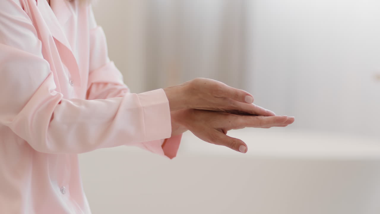 Close-up of a Person Applying Hand Cream