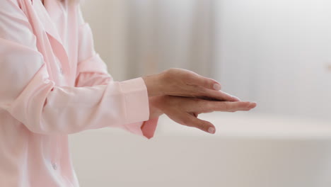 close-up of a person applying hand cream