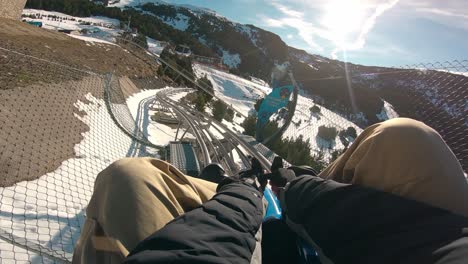 Luge-Style-Slide-Tourist-Attraction-at-Ski-Resort-Snowy-Mountain,-POV