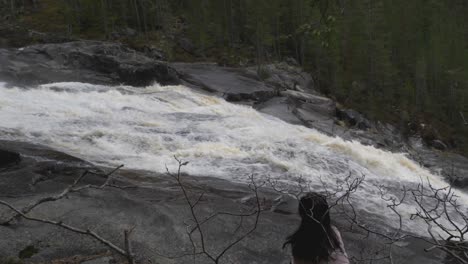 girl sits by a crazy river