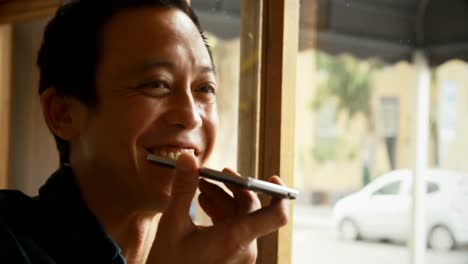 man talking on mobile phone in the cafe 4k