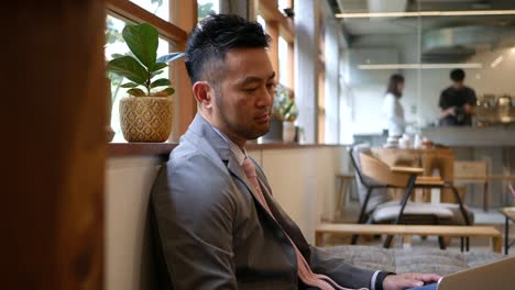 businessman working on his laptop at a cafe