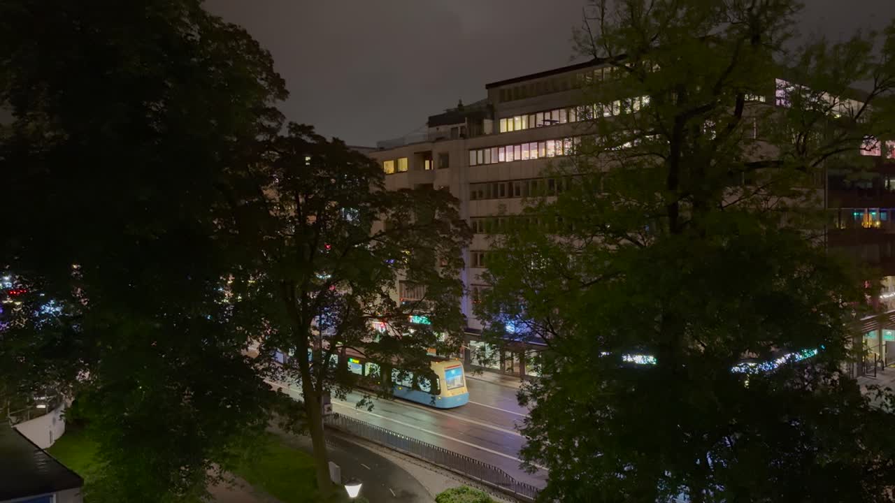 Night view of a city street with traffic and buildings