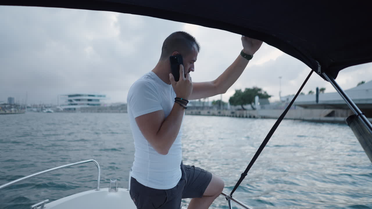 Man on a boat talking on a mobile phone