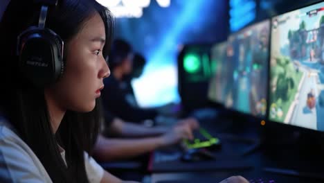 intense focus in gaming: a young gamer competing in an electrifying e-sports environment with high-tech gear and high-definition graphics