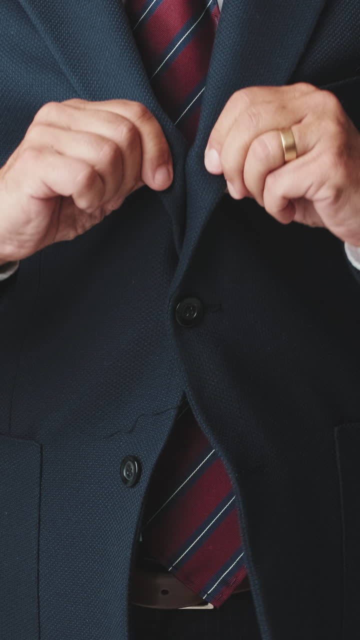 Professional Man Buttoning His Suit Jacket and Crossing Arms