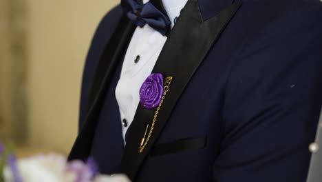 Slow-motion-shot-of-a-groom-wearing-a-blue-suit-with-purple-accents