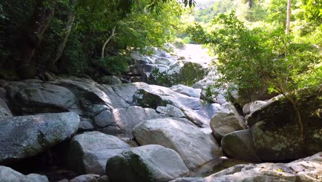 Natural-Stream-Water-flowing-between-rocks-during-sunny-day-in-Colombian-Amazon-Rainforest