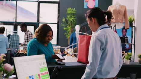 woman paying with smartphone