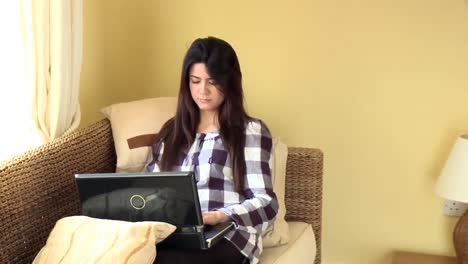 Concentrated-woman-looking-at-her-laptop