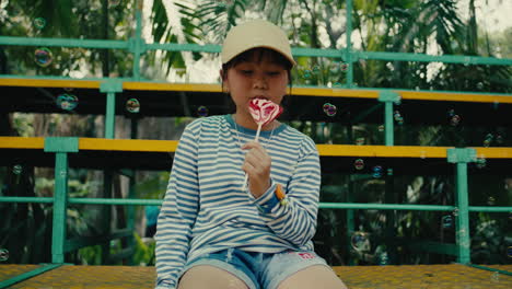 happy girl with lollipop and bubbles