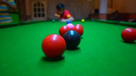 player playing snooker on green table on night for relaxing time
