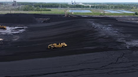 Grader-working-a-pile-of-coal-for-the-DTE-Belle-River-Power-Plant,-aerial-view