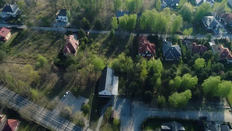 Descending-from-above-to-modern-house-with-solar-panels-on-roof