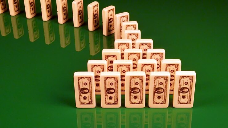 Domino Effect Illustrating the Chain Reaction of Economic Collapse, High Unemployment, Business Failures, and Stocks Crashing in a Bear Market Economy
