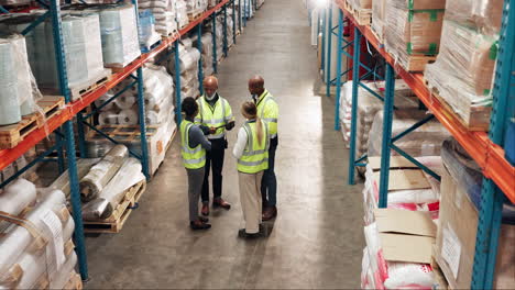 warehouse workers meeting in distribution center