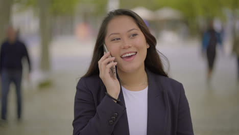 cheerful girl talking by cell phone outdoor