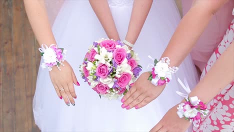 bridesmaids with floral bouquets and wristbands