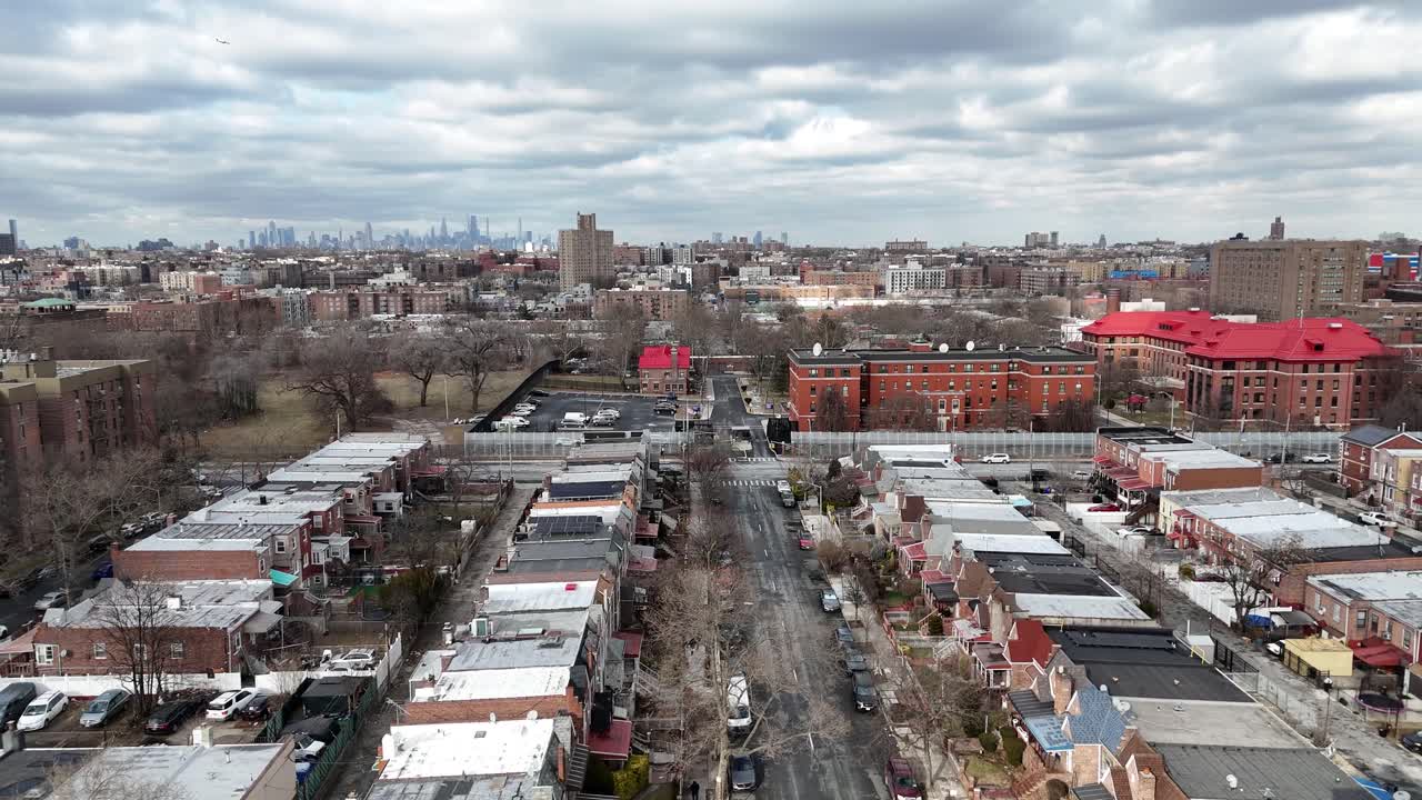 Horizontal drone ascending shot over Troy Ave, Brooklyn, revealing New York’s vibrant rooftops, urban streets, and dynamic cityscape from a rising aerial perspective.