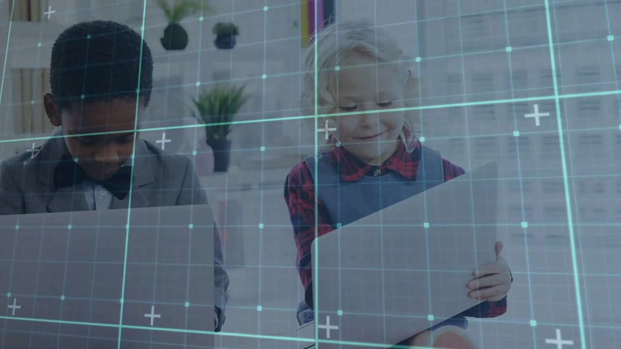 Girl angling laptop, boy typing in classroom, causing digital grid overlay over laptops for study