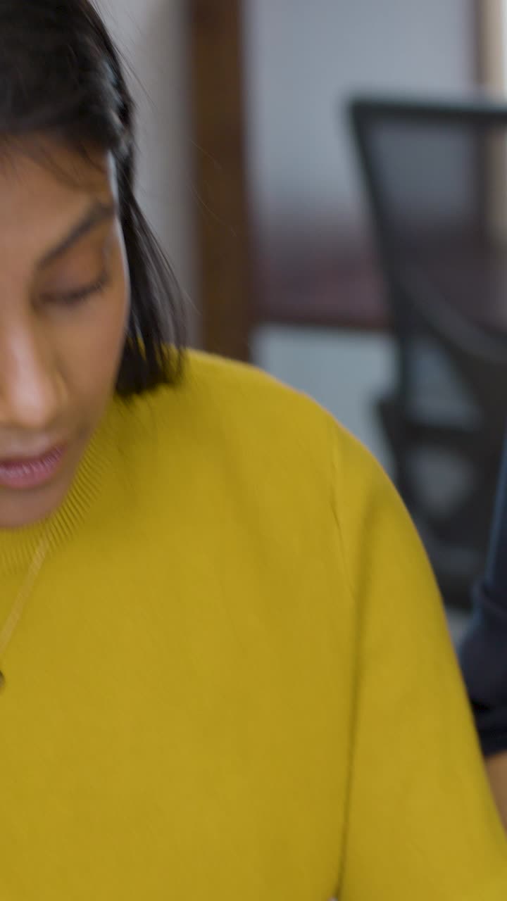 Close Up Of Businesswoman Talking With Group Of Colleagues In Office